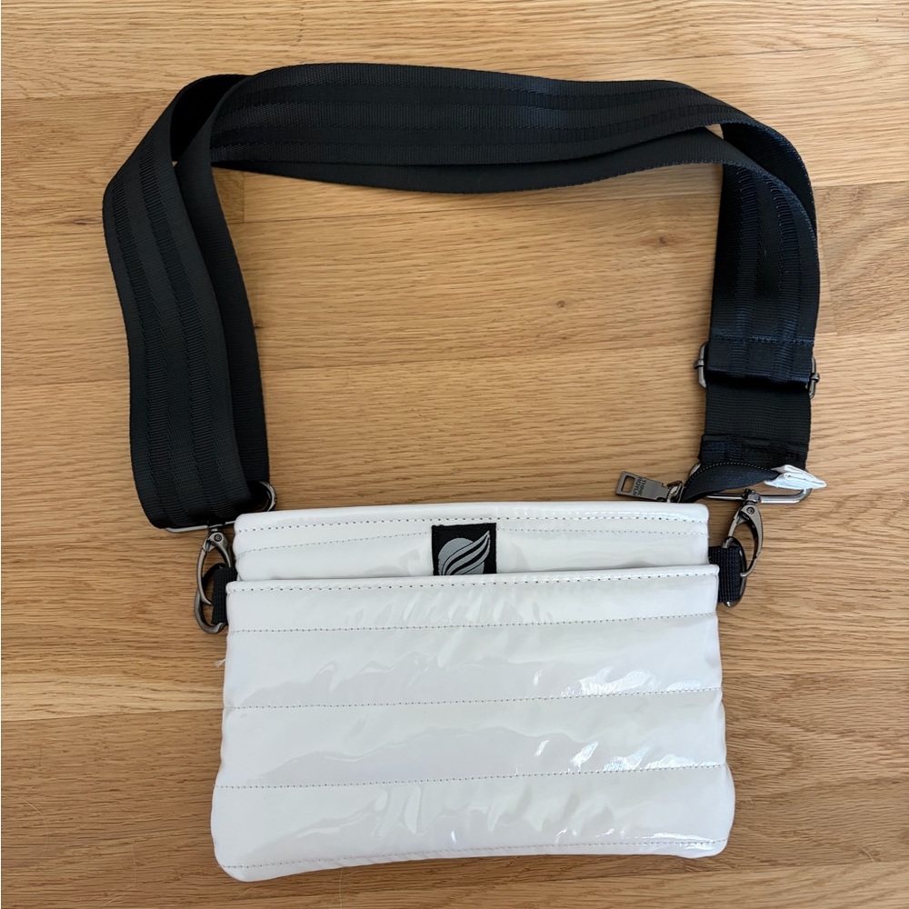 THINK ROLYNS glossy White Quilted Crossbody Bag with Wide Black Strap